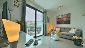 A modern living room with a sofa, coffee table, and a large window. - PREMIUM VACATION HOME WITH SEAVIEW (Funtana)