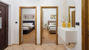 Una habitación de hotel con cama, mesita de noche y espejo.