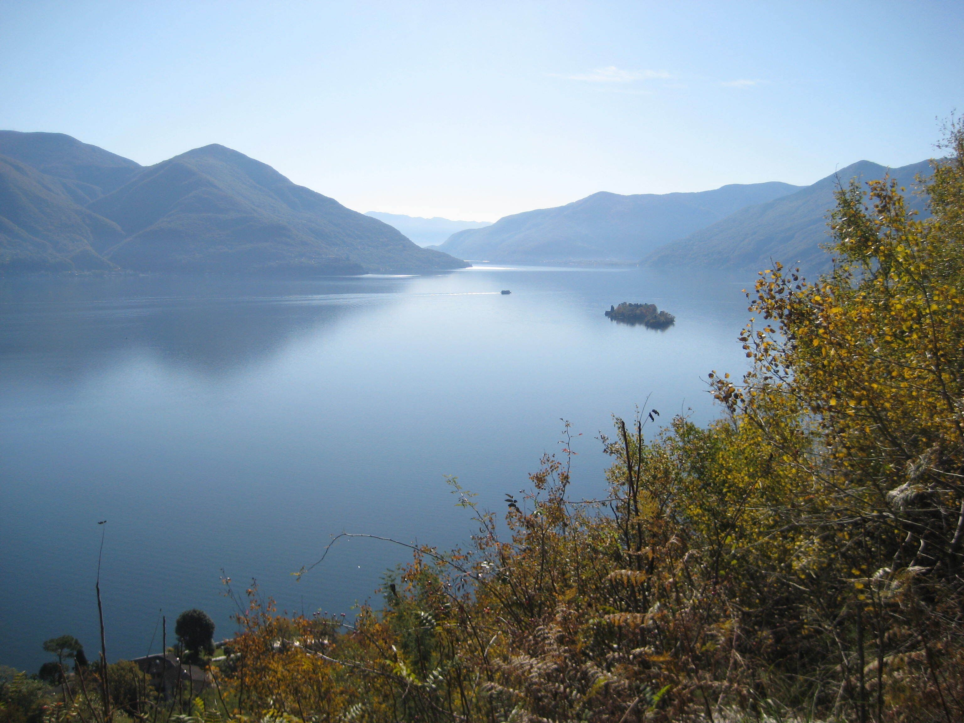 A calm lake surrounded by mountains.