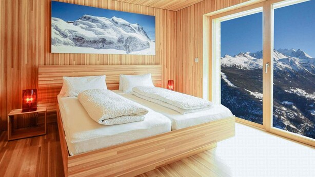 A modern bedroom with a wooden ceiling, a large bed with white linens, a painting of a mountain, and a large window with a mountain view. - Exclusive design chalet on 1 800 meters, 4-6 pers.,  above Törbel (Törbel)