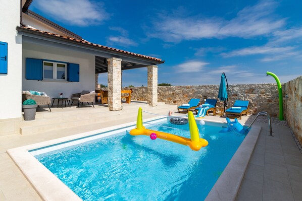 A swimming pool with lounge chairs and a covered seating area. - Warm, sunny, private and family friendly villa, where pets are welcome (Svetvinčenat)