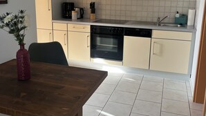 A modern kitchen with light-colored cabinets, a built-in oven, and a stainless steel sink. - Idyllic natural oasis - pure tranquillity just 5 minutes' walk from the Müritz  (Ludorf)