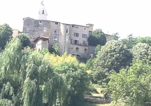 A historic building with multiple windows and a bell tower, surrounded by lush greenery. - Cosy house with garden and private pool 15 minutes from Lyon in the Beaujolais region (Chazay-D'azergues)