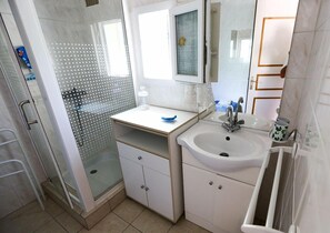 Shower, hair dryer, towels, toilet paper