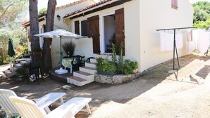 Une maison dotée d’un patio, d’un espace salon extérieur et d’un fil à linge.