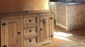 A wooden cabin interior with a kitchen area featuring a wooden cabinet with drawers and a stone countertop. - CHALET SUR FLANC DE COLLINE A BESSE PROMO last minute in May (Besse-Et-Saint-Anastaise)