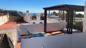A rooftop terrace with a pergola, a pool table, and a view of the sea. - Village house with large rooftop terrace near the beach (Maro - Nerja)
