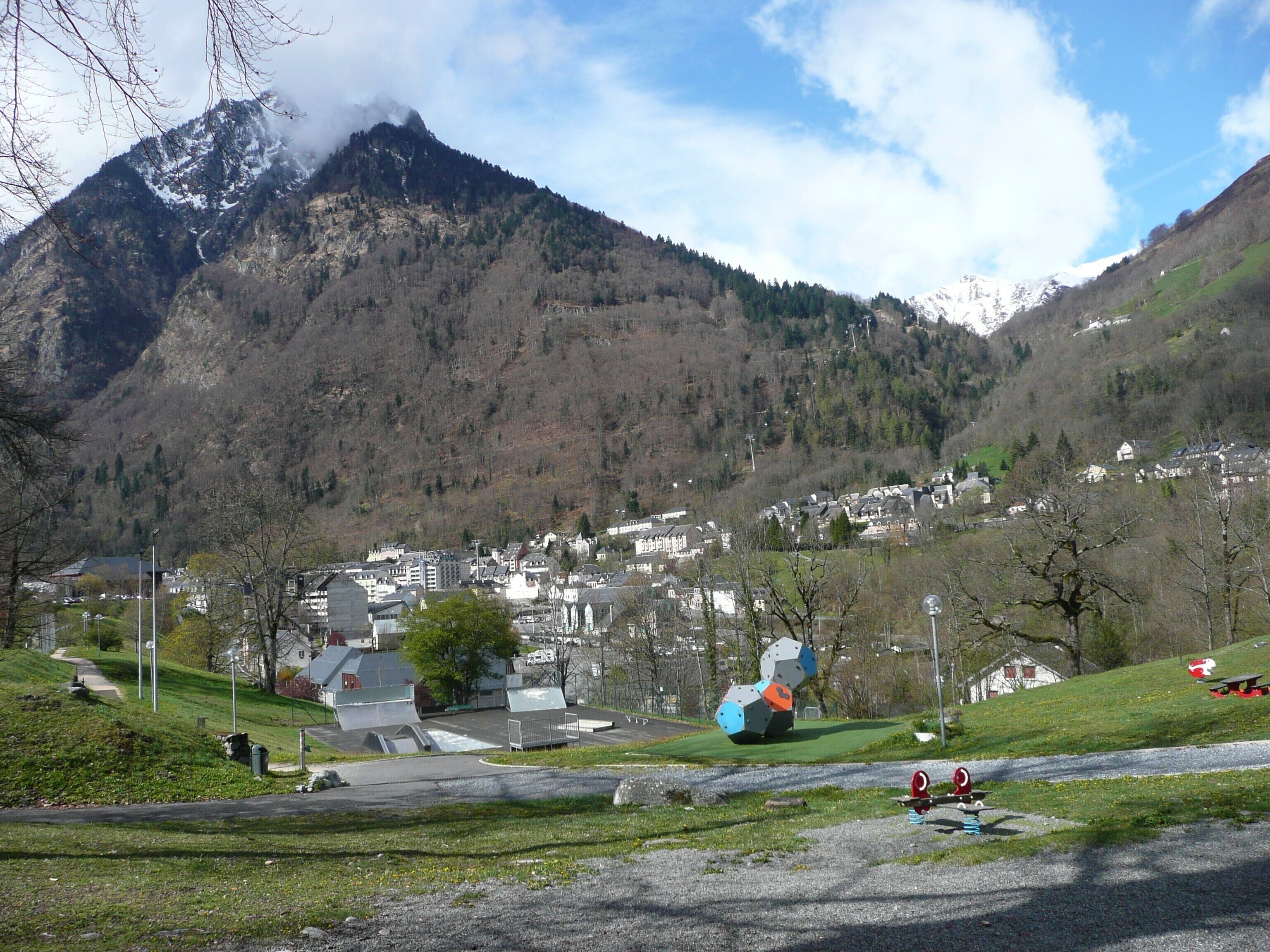 Un paisaje montañoso con un pueblo en el valle.