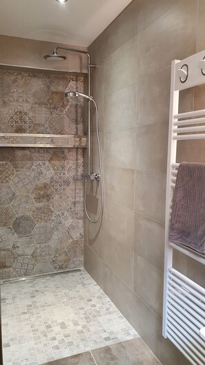 Een douche, een haardroger, handdoeken, toiletpapier