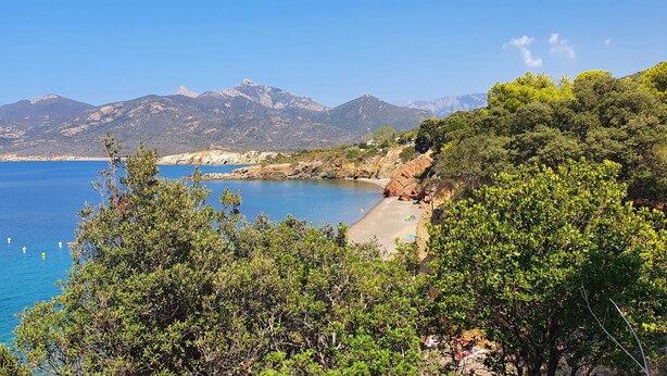 A coastal landscape with a beach, boats, and mountains in the background. - Quiet village, panoramic view, Scandola reserve, warm river Le Fango (Galéria)
