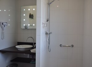 Shower, hair dryer, towels, toilet paper