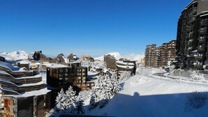 A snowy mountain town with modern buildings, including a mix of high-rise and low-rise structures, and a clear blue sky. - Avoriaz center, Large  Studio on two levels:rented from Saturday to Saturday  (Morzine)