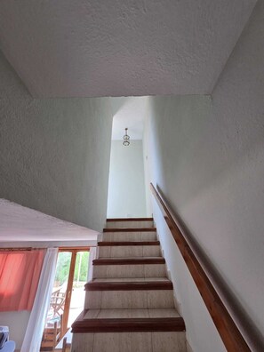 A staircase with wooden handrails and a light-colored wall. - Wonderful country house with private pool (El Perelló)