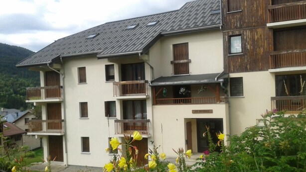 A multi-story building with balconies, a sign reading "LE HOUSSEY", and surrounding greenery. - Lelex Monts-Jura to rent studio facing south and resort center  (Lélex)