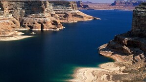 A coastal landscape with cliffs and a clear blue sea. - Relax In Southern Utah's Color Country! (MOUNT CARMEL)