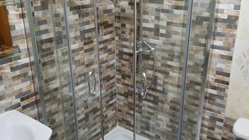 Shower, hair dryer, towels, toilet paper