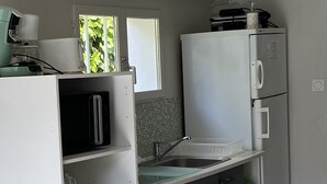 A modern kitchen with grey cabinets, a white refrigerator, a stainless steel sink, and two pendant lights. - holiday apartment seaside comfort air-conditioned  (Hyères)