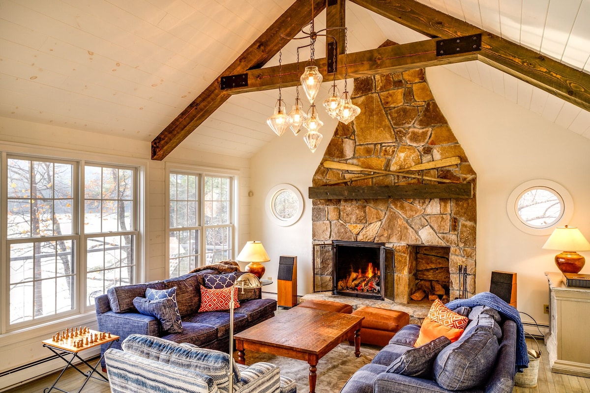 A Vermont vacation rental with a large stone hearth and living area that overlooks lake