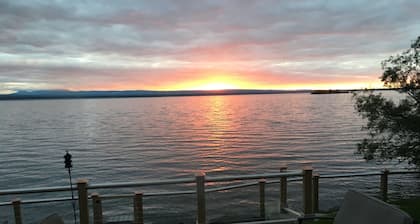 Family Friendly Lake Front Property on the Water's Edge. Spectacular Setting.