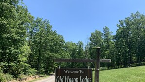 A welcome sign for Old Wagon Lodge at 427 Old Wagon Rd. - Old Wagon Lodge | Spacious Retreat | WiFi & Hot Tub + Theater Room (Luray)