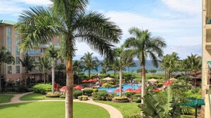 A resort with a swimming pool, palm trees, and a view of the ocean. - Klvr presents Honua Kai Resort K238*Quiet location (Lahaina)