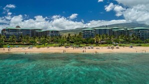 A beachfront hotel with multiple buildings, clear turquoise water, and a sandy beach. - Klvr presents Honua Kai Resort K238*Quiet location (Lahaina)