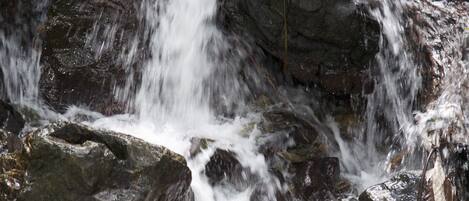 A waterfall cascading over rocks in a natural setting.