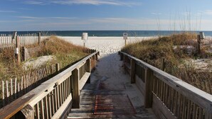 A wooden boardwalk leading to a sandy beach with a clear sky. - End of Year Special Unit #413 Rates-Beachfront Beautifully Renovated  2/2Sleeps8 (Orange Beach)