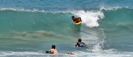 A beach scene with surfers and waves.