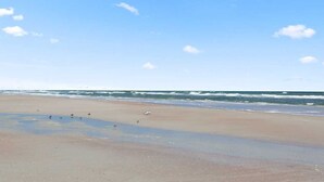 A beach with a clear sky and calm sea. - Villas of Ocean Gate #106 Ocean side 2 bedroom, pool view, pet friendly (St Augustine)