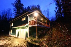 A two-story house with a covered porch and a garage. - Mountain Chalet with Hot Tub, Gameroom and Wifi, Sleeps up to 10 (Glacier)
