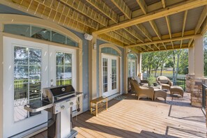A covered patio with a grill, outdoor seating, and a view of the surrounding area. - Nashville Old Hickory Lake Home on Old Hickory Lake (Mt Juliet)