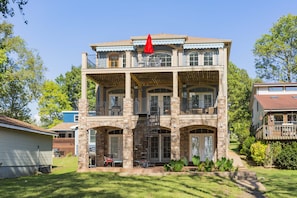 A two-story house with a balcony, a staircase, and a front porch. - Nashville Old Hickory Lake Home on Old Hickory Lake (Mt Juliet)
