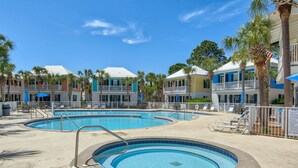 A resort with multiple swimming pools, lounge chairs, and palm trees. - Walk to a public beach! Walk to restaurants! True Owner Operator. (Santa Rosa Beach)