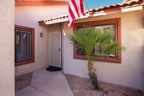 A house with a door, windows, and a flag.