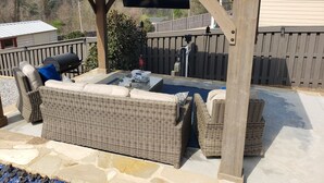 An outdoor patio with a covered seating area, a grill, and a water feature. - Year round rental 4 miles from the Augusta National pool Hot tub Gym tanning bed (North Augusta)