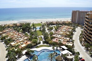 A resort with a central swimming pool, beachfront, and multiple buildings with balconies. - Bella Sirena 3 room Penthouse with Amazing views (Puerto Peñasco)