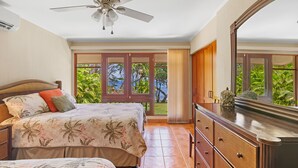 A bedroom with a bed, a dresser, a ceiling fan, and a view of the outdoors. - Beachfront, Private Pool, Pure Luxury at  Bahia Pez Vela, Villa Las Olas #4 (Playa Ocotal)