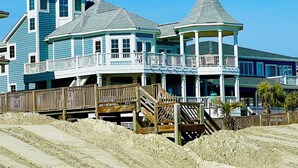 A large, multi-story beachfront house with a prominent tower and a gazebo. - Oceanfront & Soundfront! Luxury Beachfront, Pool, Private Exclusive West End   (Ocean Isle Beach)