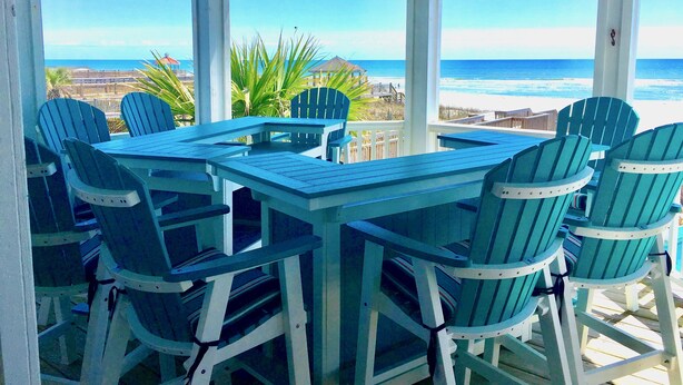 A covered outdoor seating area with a view of the beach and ocean. - Oceanfront & Soundfront! Luxury Beachfront, Pool, Private Exclusive West End   (Ocean Isle Beach)