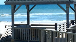 A wooden beach gazebo with a simple roof and a wooden railing, overlooking the ocean. - Oceanfront & Soundfront! Luxury Beachfront, Pool, Private Exclusive West End   (Ocean Isle Beach)