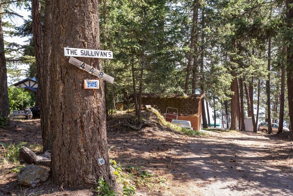 A tree with a sign reading "The Sullivan's" and a smaller sign with the number "21415".