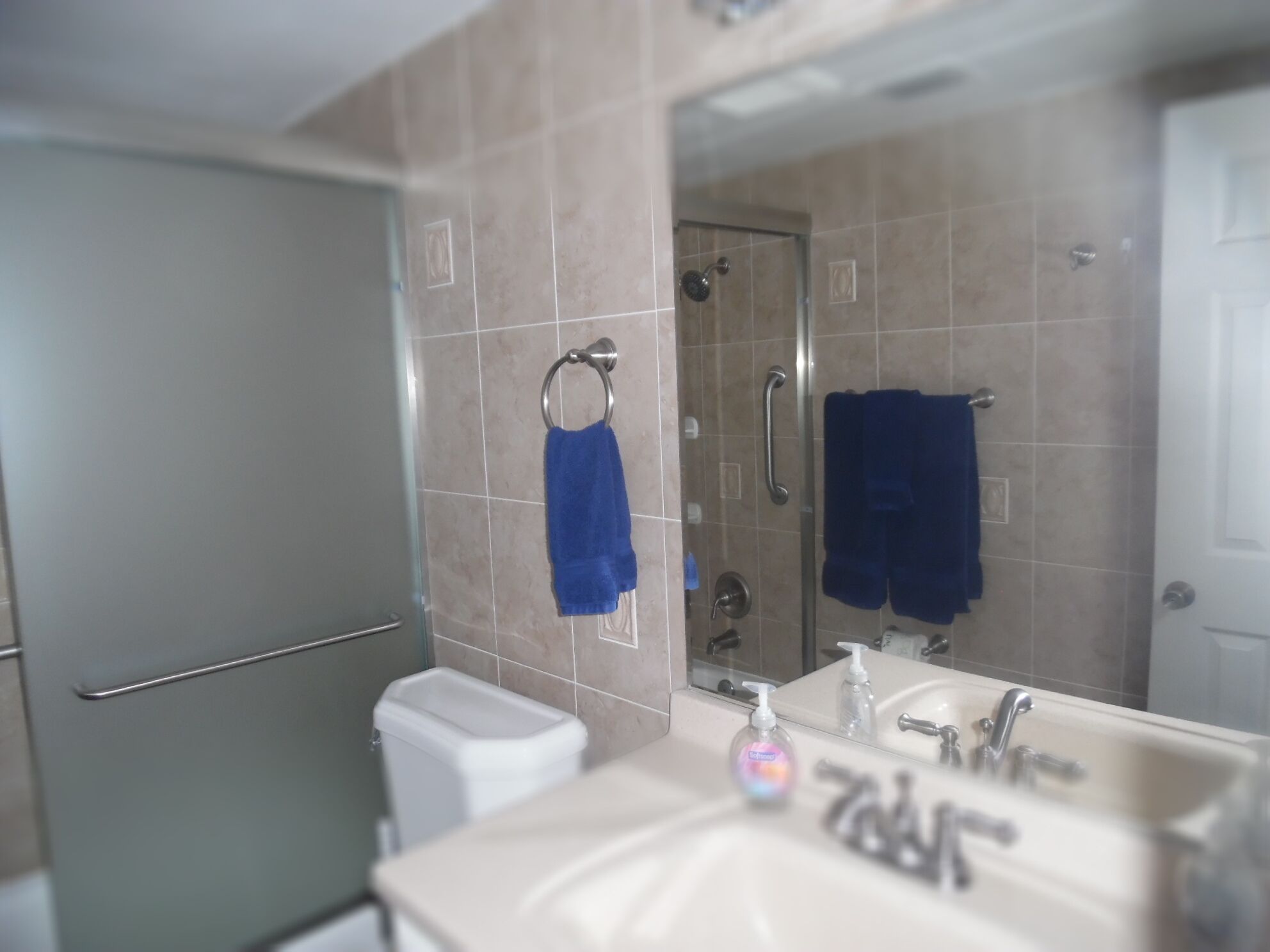 A bathroom with a toilet, sink, and shower.