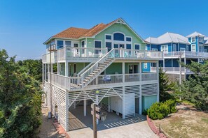 A multi-story beachfront property with a balcony, a staircase, and a pool area. - Semi-Oceanfront Home w/ Private Pool, Hot Tub, Game Room, Community Tennis (Waves)