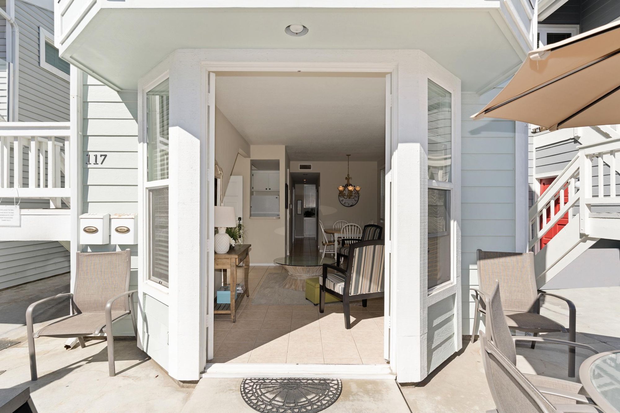 A house entrance with a dining area visible inside.