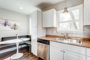 Enjoy cooking in this well-lit kitchen with a dishwasher and granite countertop.