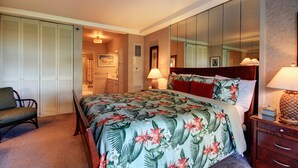 Une chambre d’hôtel avec un lit, une chaise, une table de chevet et un grand miroir.