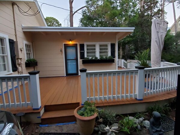 A house with a wooden deck, a blue door, and a white railing. - Few short steps from the beach (Grayton beach)