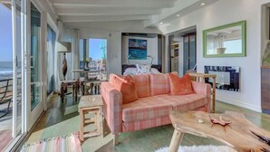 A living room with a checkered sofa, a wooden coffee table, and a painting on the wall.