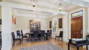 A dining room with a chandelier, wooden dining table, and chairs. - Tons of Space & Gorgeous Porch! (Savannah)